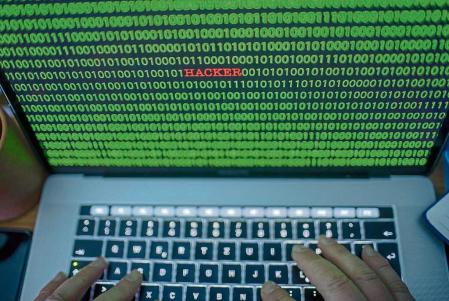 04 January 2019, Mecklenburg-Western Pomerania, Schwerin: ILLUSTRATION - Between the binary code on a laptop monitor you can see the text